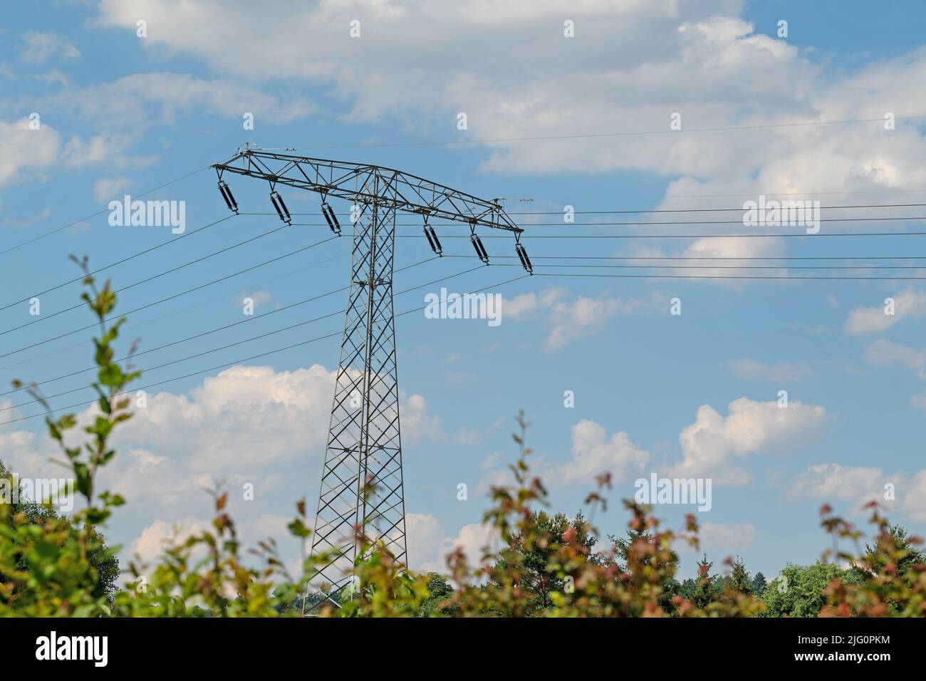 Electricity pylon in front of sky with clouds Stock Photo - Alamy