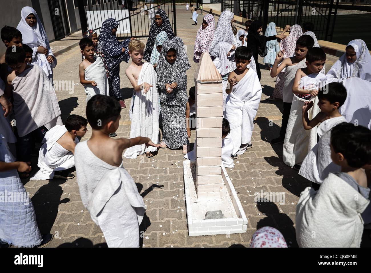 Atmeh, Syria. 05th July, 2022. Syrian children perform the 'Jamarat'  ritual, the stoning of Satan, during an educational simulation of the Hajj  pilgrimage at a school in the Syrian city of Atmeh.