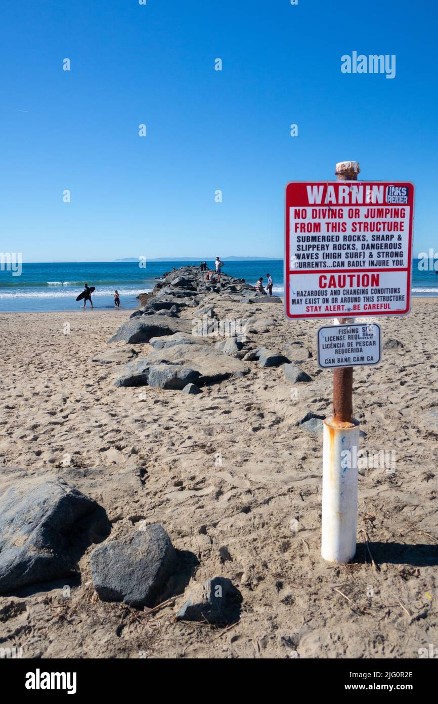 Warning sign. no diving jumping from rocks and caution hazardous and changing contitions . Stay alert and be careful. Stock Photo