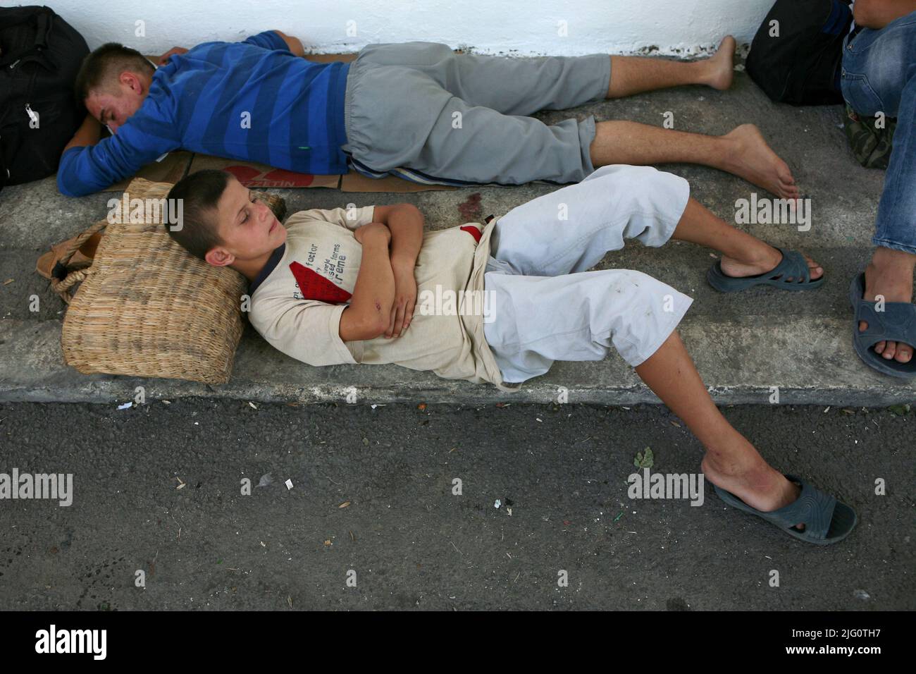 Kırkpınar (Turkish Oil Wrestling). Young wrestlers sleep as they wait for the beginning of the opening ceremony next to the stadium during the 648th Kırkpınar Tournament in Edirne, Turkey, on 3 July 2009. Stock Photo