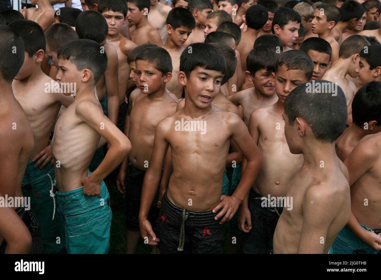 Kırkpınar (Turkish Oil Wrestling). Young wrestlers wait for the beginning of the opening ceremony on the stadium during the 648th Kırkpınar Tournament in Edirne, Turkey, on 3 July 2009. Kırkpınar wrestlers compete stripped to the waist and smeared their bodies with olive oil. About one thousand wrestlers from across the country, the winners of regional competitions, attend the three-day tournament every year. Stock Photo