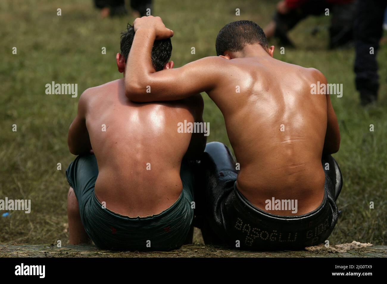 Kırkpınar (Turkish Oil Wrestling). Young wrestlers react after losing their fights during the 648th Kırkpınar Tournament in Edirne, Turkey, on 5 July 2009. Kırkpınar wrestlers compete stripped to the waist and smeared their bodies with olive oil. Stock Photo