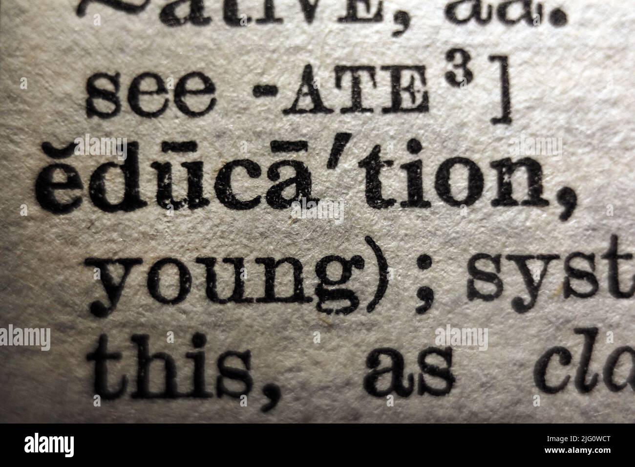 Word 'education' printed on dictionary page, macro close-up Stock Photo