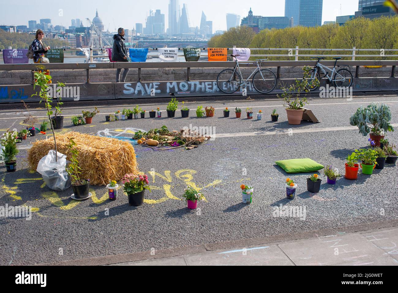 Waterloo Bridge, London, covered in colorful slogans by supporters of the Extinction Rebellion campaign in protest of world ecological climate change. Stock Photo