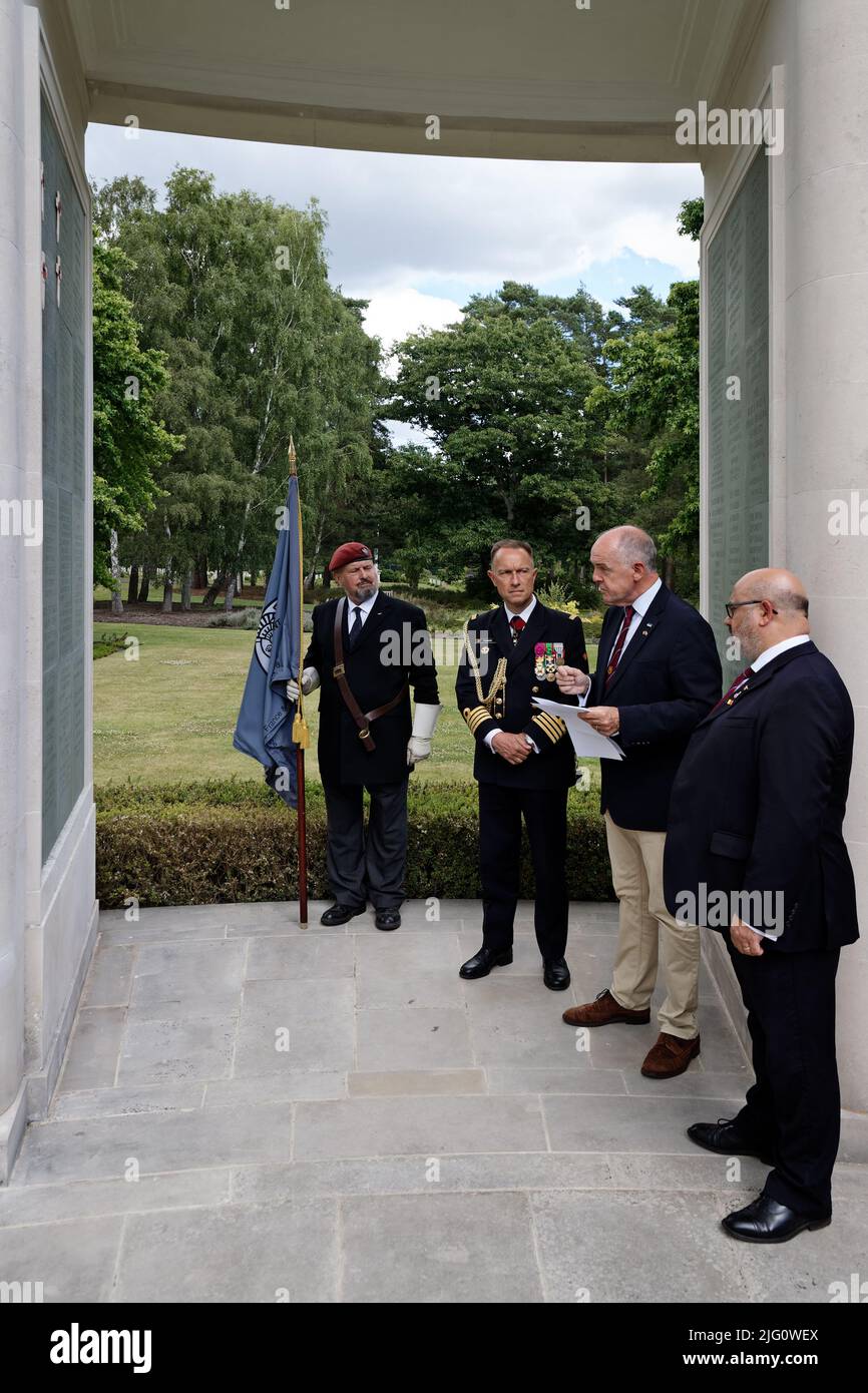 Sun 3rd July 22. At the 1939-45 Brookwood Memorial Panel 22 with crosses identifying the names of Belgian SOE Agents without a grave are L to R: Paul McCue, author & military historian; Captain (Naval) Renaud Flamant Defence Attaché of the Embassy of the Belgian Kingdom in the UK; Kevin Davis, Chair of the Brookwood Last Post Association and Edward Jones, Artist Rifles Standard Bearer. Paul is recounting his research of the life stories of the agents. Stock Photo