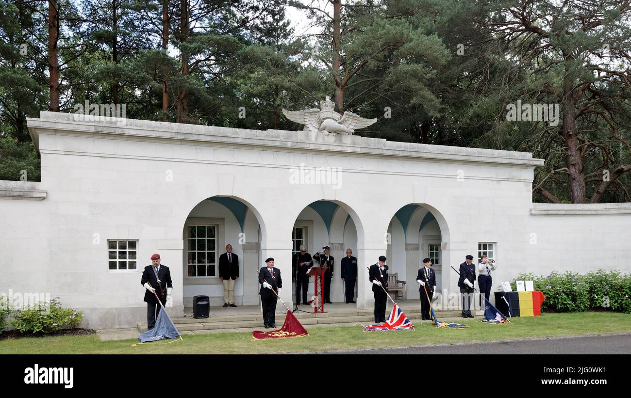 Sun 3rd July 22. At the Air Forces Shelter, Brookwood Military Cemetery Ruth Moore, Woking Scouts sounds Last Post with Standards dipped and Captain (Naval) Flamant, Belgian Defence Attaché saluting. This was a service remembering & honouring Belgian SOE Agents & war casualties organised by the Brookwood Last Post Association. Stock Photo