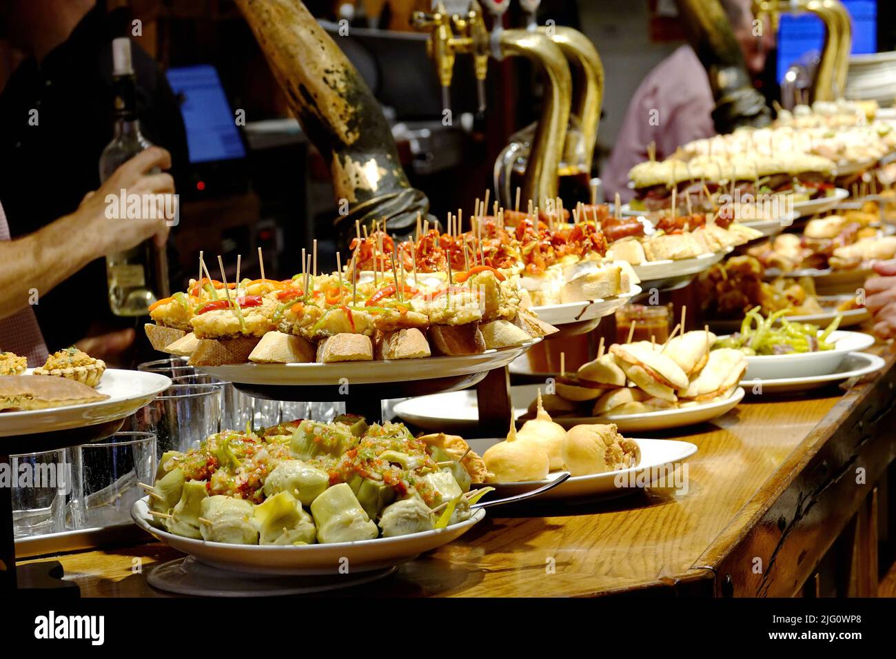 A tapas bar in San Sebastian with delicious pintxos, the traditional appetizers of the Basque country. San Sebastian, Spain - August 2018 Stock Photo