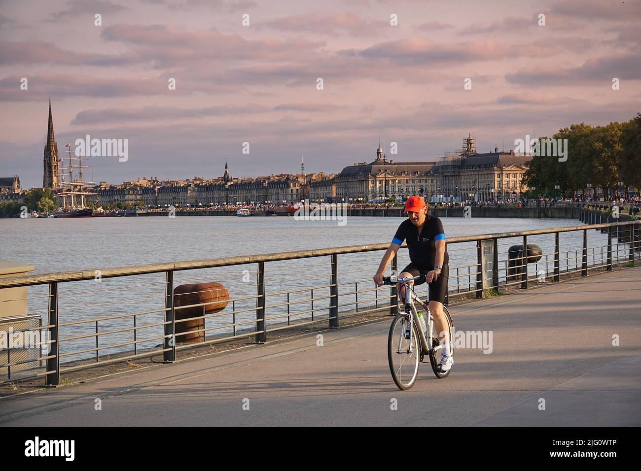 Bordeaux, France - august 2018: people biking along the river in the quay of the French city Bordeaux Stock Photo