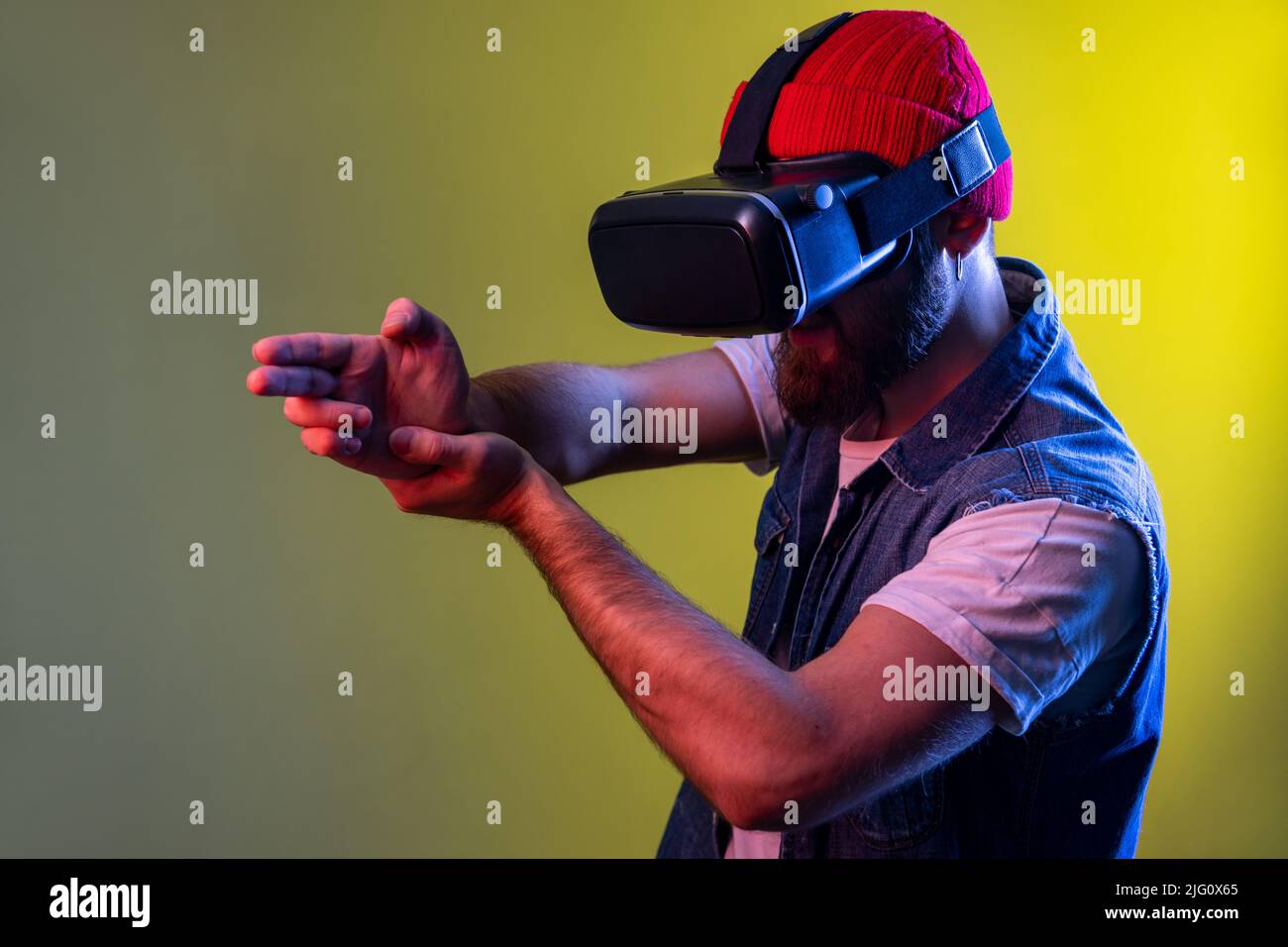 Hipster man with virtual reality glasses playing shooter game, pointing