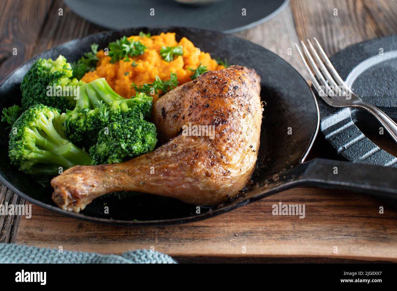 Fitness recipe with grilled chicken leg, mashed pumpkin and broccoli Stock Photo