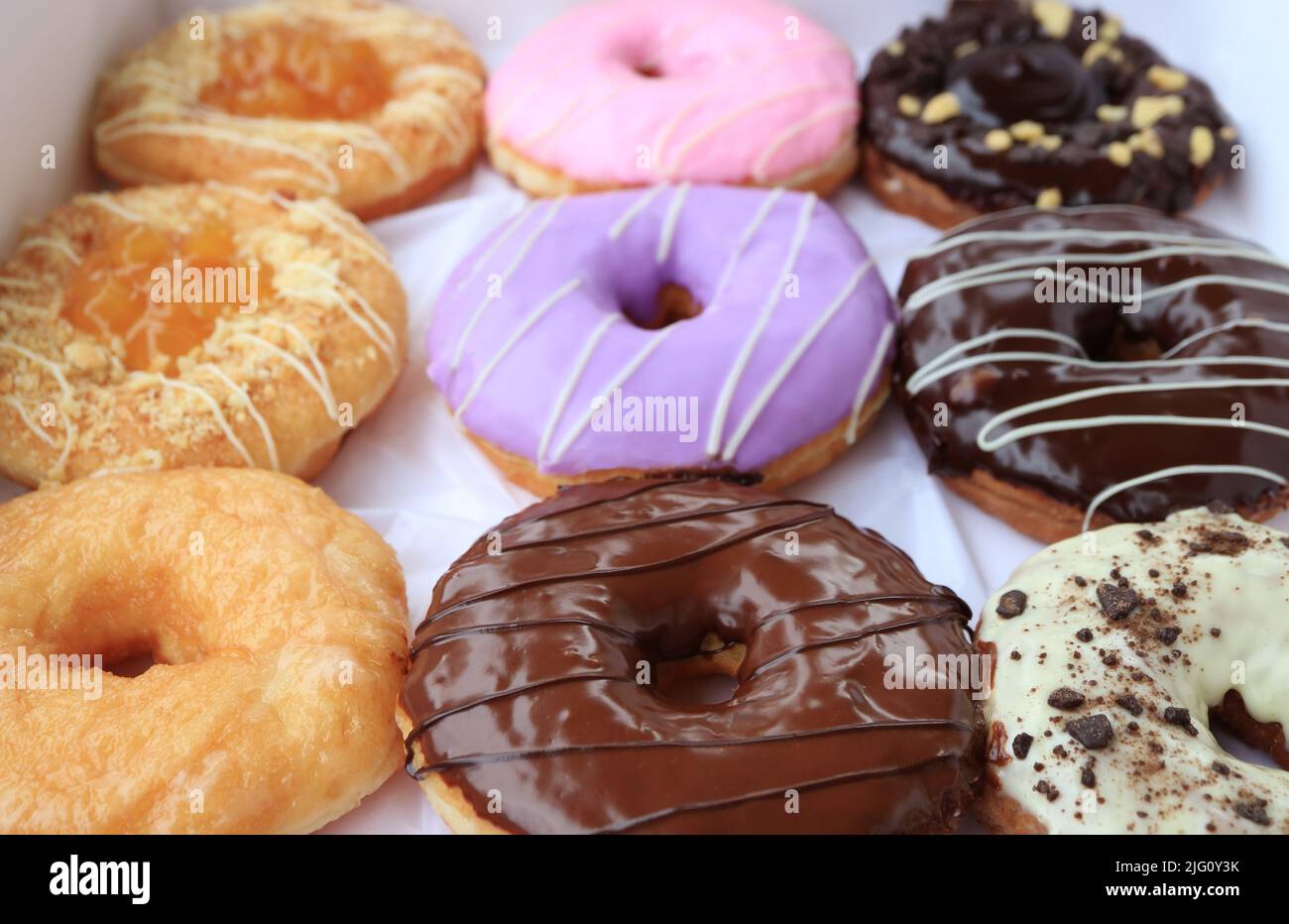 Closeup of delectable assorted doughnuts in a box Stock Photo