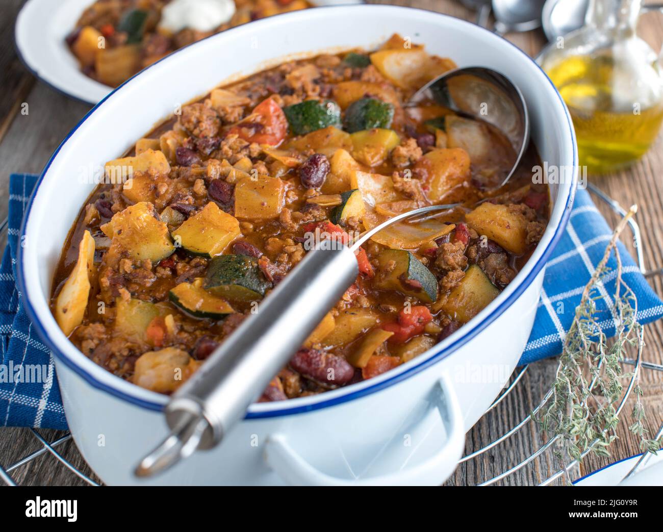 Healthy family meal with a minced meat stew, cabbage, vegetables and kidney beans. Served in pot on kitchen table Stock Photo