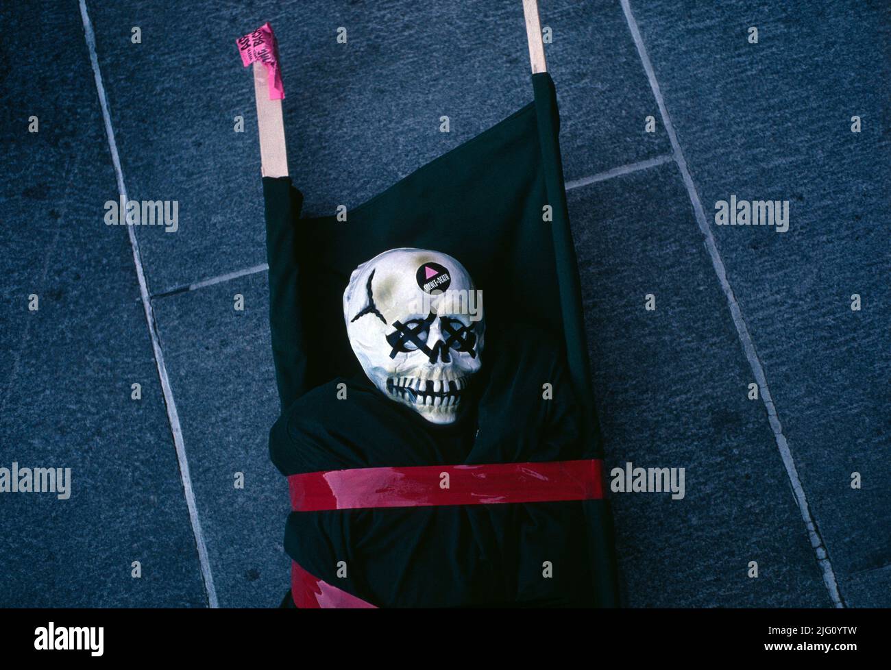 Act Up / San Francisco. Black shrouded mannequin body and skull on a stretcher outside the entrance to the United States Federal Building in San Francisco, CA, during a National Day of Protest called “Living with AIDS and Fighting Back” by Act Up in October 1989. Stock Photo