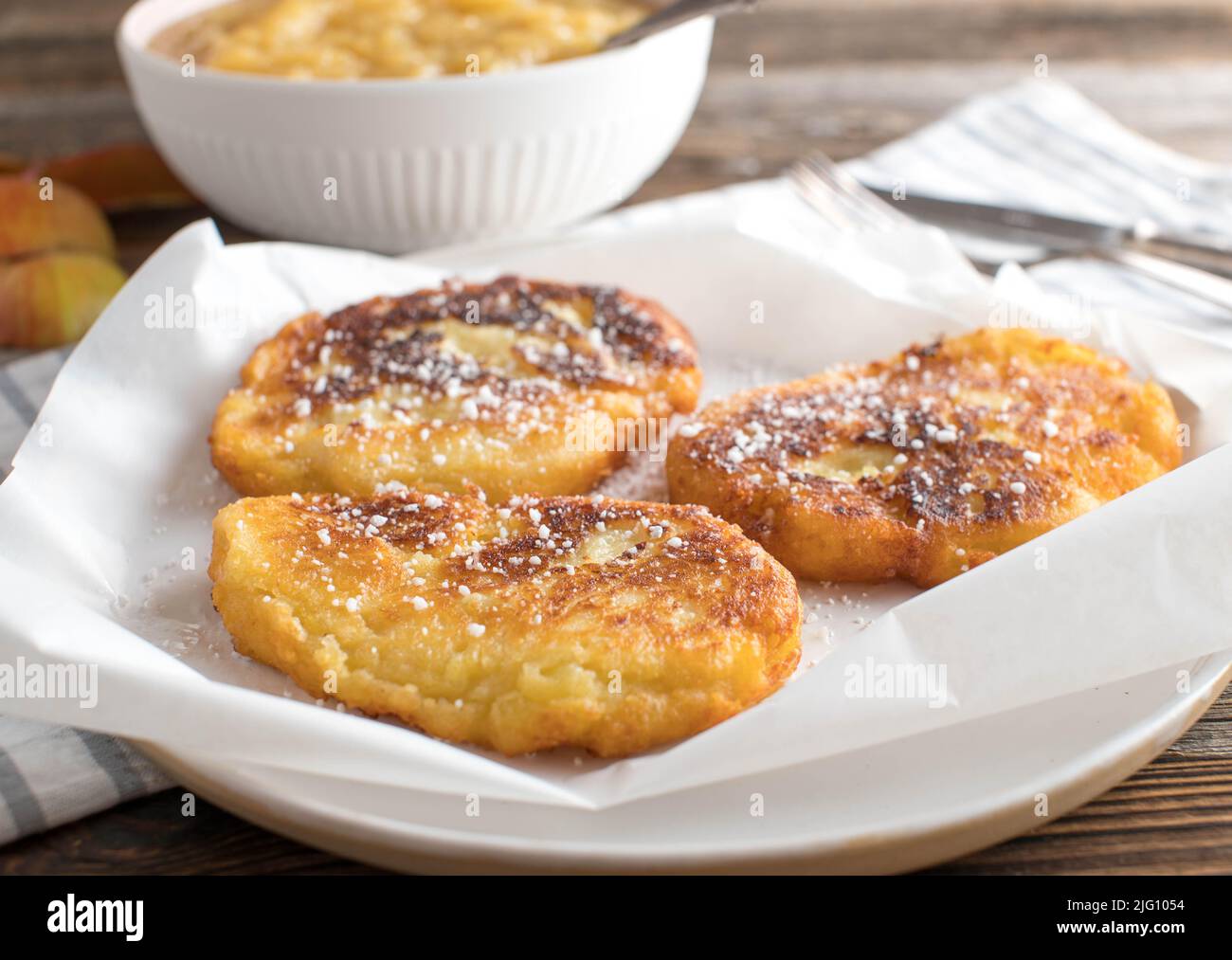 Potato quark pancakes with homemade apple sauce. Traditional recipe from East Germany 'Quarkkeulchen' Stock Photo