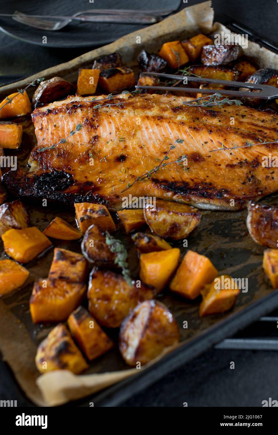 Roasted whole salmon fillet with potatoes Stock Photo