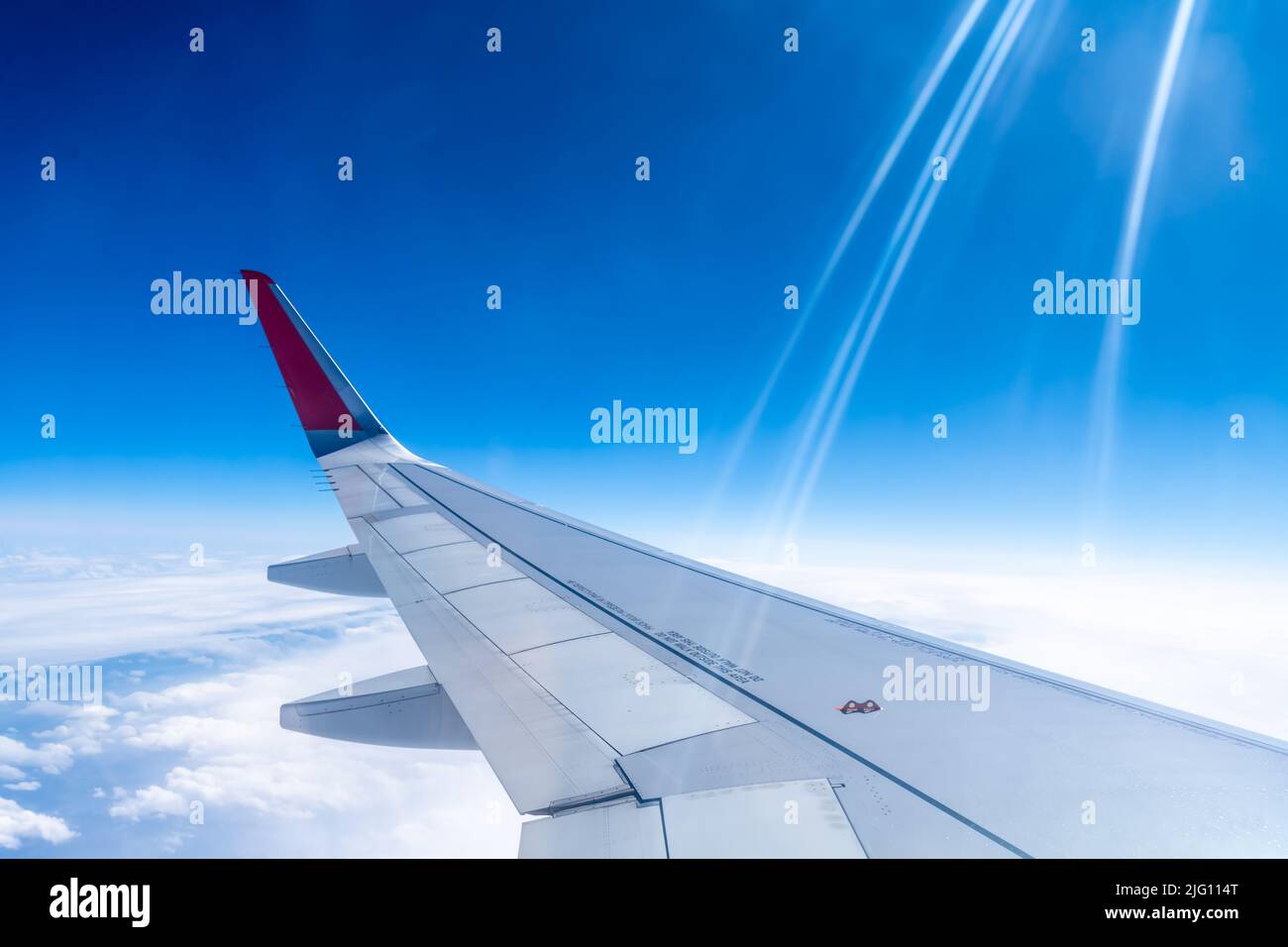 the wing of the aircraft against the sky and white clouds Stock Photo ...