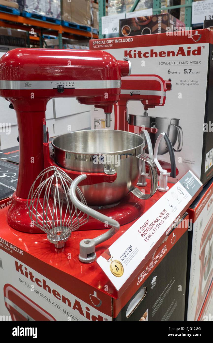 Close-up of red Kitchenaid blender and white Kitchenaid mixer on  kitchen worktop below storage shelves Stock Photo - Alamy