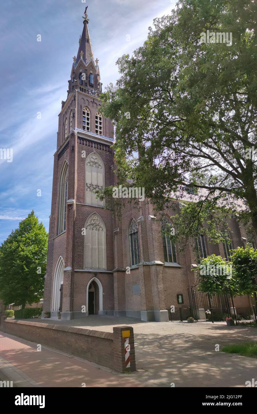 Tall catholic church in neogothic style called Laurentiuskerk in the village of Voorschoten, The Netherlands Stock Photo