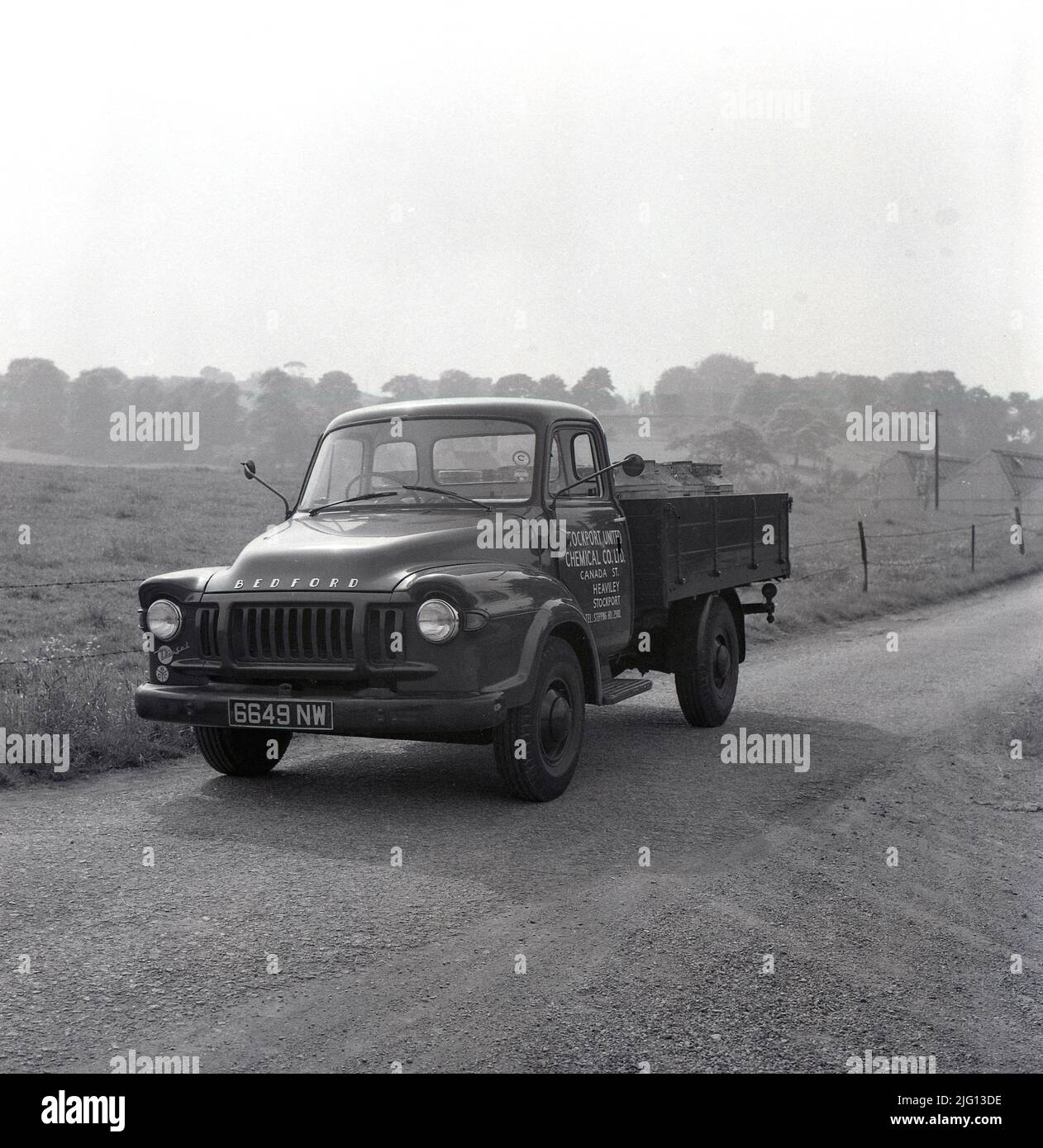 1959, historical, a Bedford TJ truck of the Stockport United Chemical Co Ltd, on a narrow entry road, to a rural industrial site, Stockport, Manchester, England, UK. Stock Photo