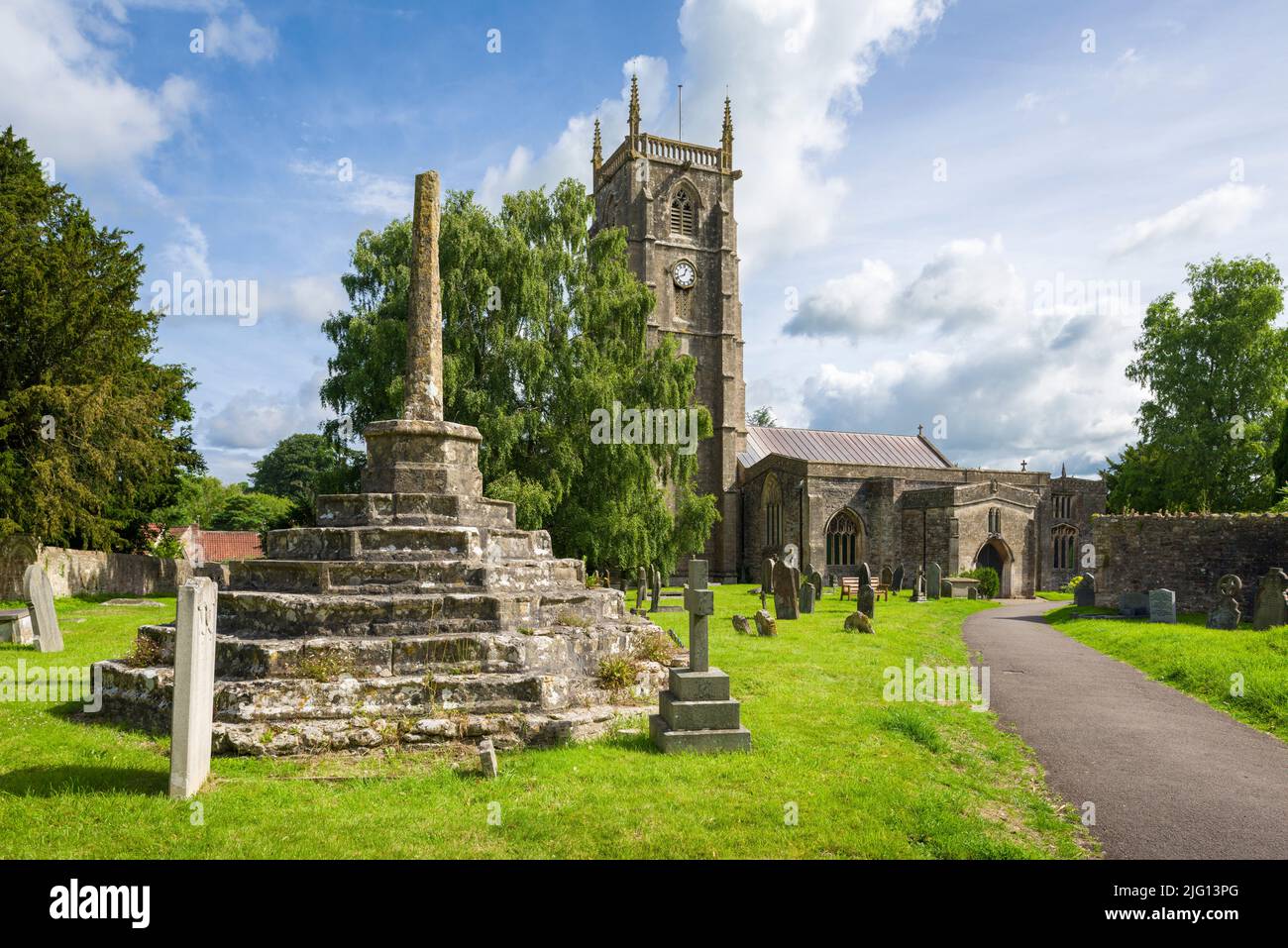 The Church of St Andrew and the churchyard cross in the village of Chew Magna, Somerset, England. Stock Photo