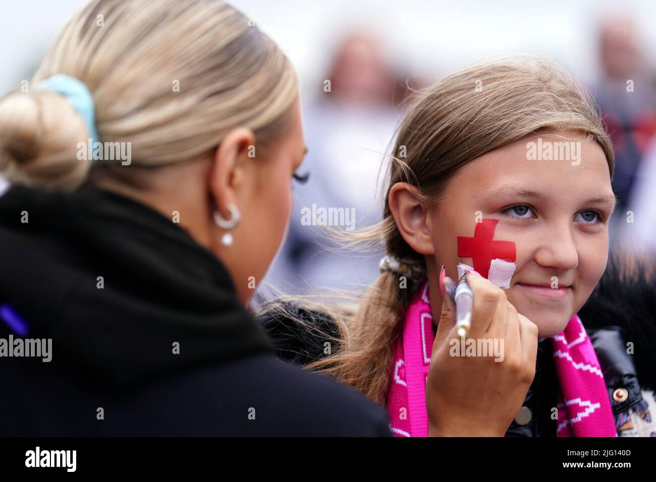 An England fan gets a St Cross face paint before the UEFA