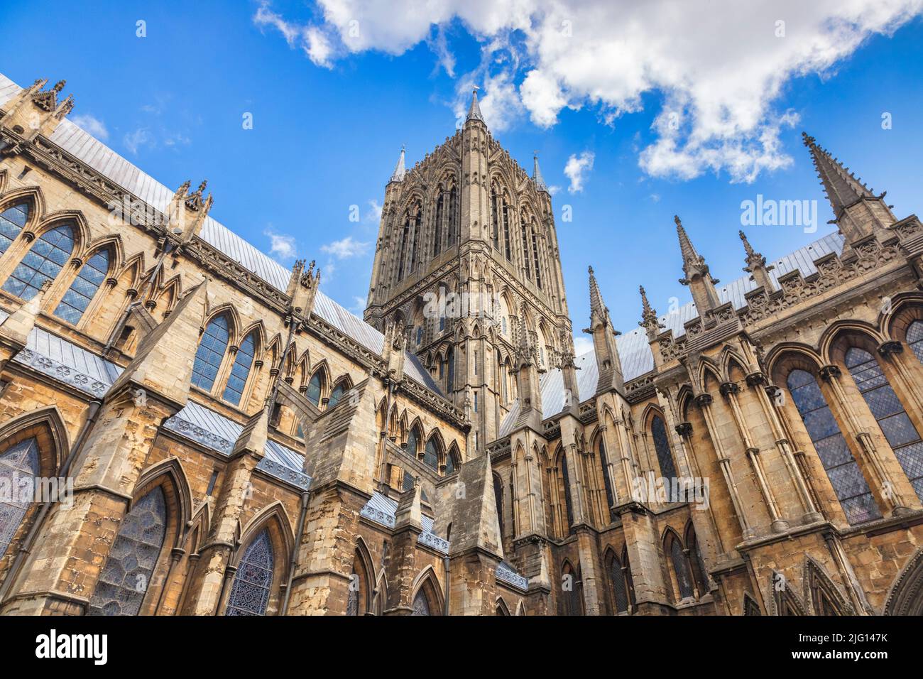 Exterior of Lincoln Cathedral, looking up to blue sky. Stock Photo