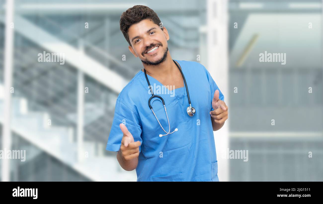 Happy hispanic male nurse with beard at clinic Stock Photo Alamy