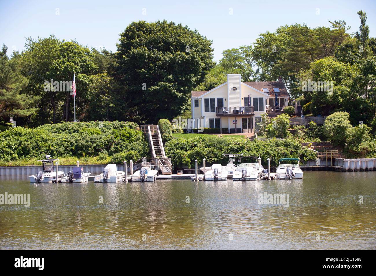 A home and docks along the Bass River in Dennis, Massachusetts on Cape Cod, USA Stock Photo
