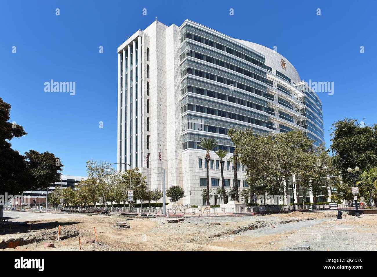 SANTA ANA, CALIFORNIA - 4 JUL 2022: Street Work for the light rail line in Downtown Santa Ana with the Ronald Reagan Courthouse in the background. Stock Photo