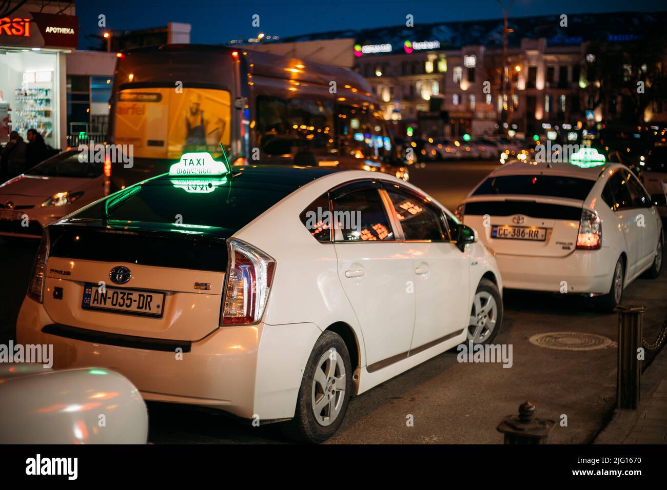 Tbilisi, Georgia - March 28, 2022: View On White Toyota's Prius Used As A Taxi. Conception Of City Trips. White Toyota Prius Plus Taxi Cars Waiting Stock Photo