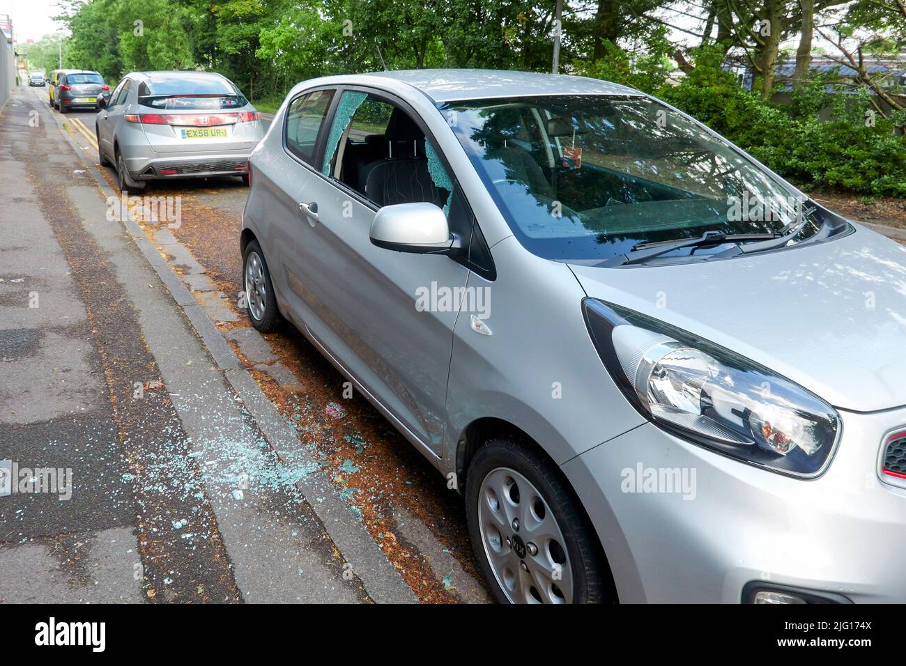 Car broken into by smashing the drivers side door window Stock Photo