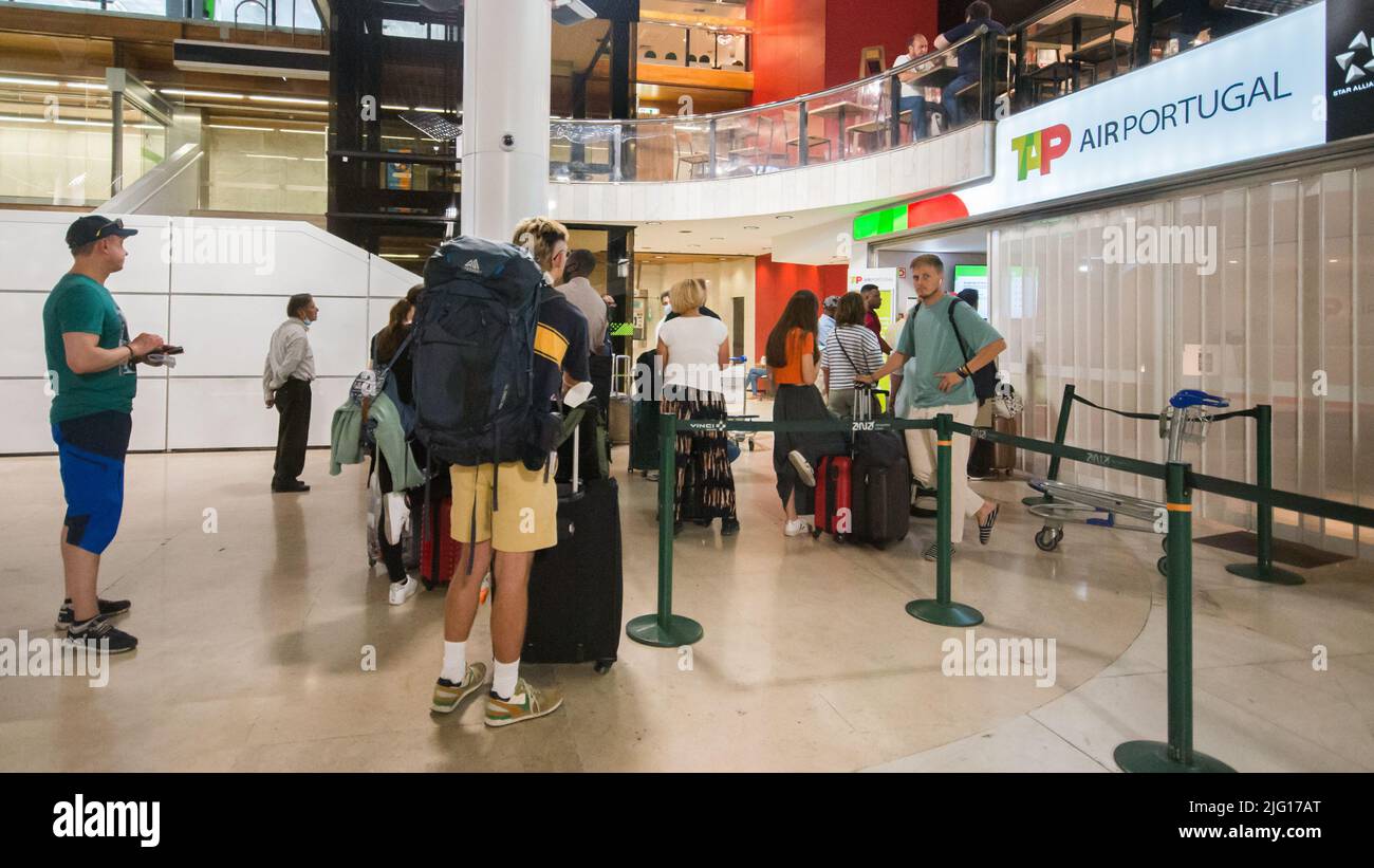 Lisbon Airport - July 6, 2022: Customers queue at the Tap customer service desk during an unusually busy period of travel disruption Stock Photo
