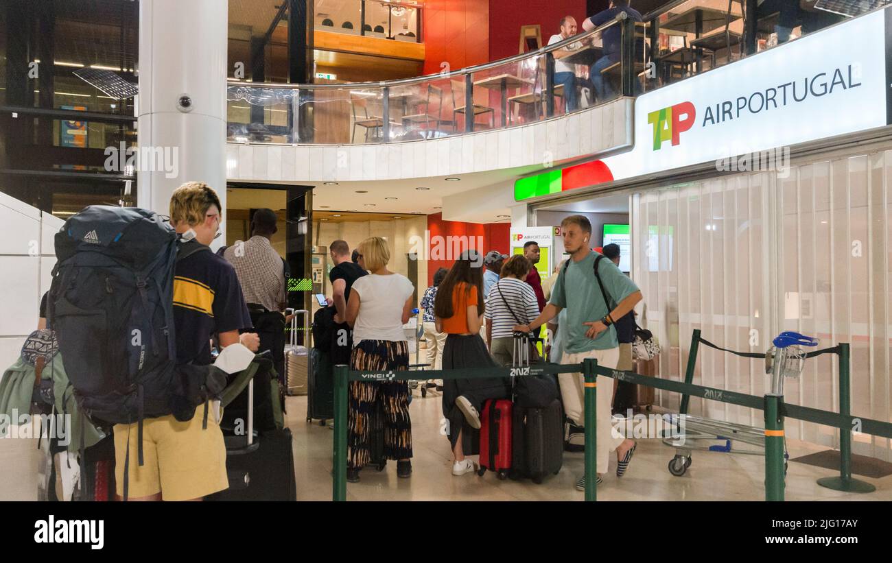 Lisbon Airport - July 6, 2022: Customers queue at the Tap customer service desk Stock Photo