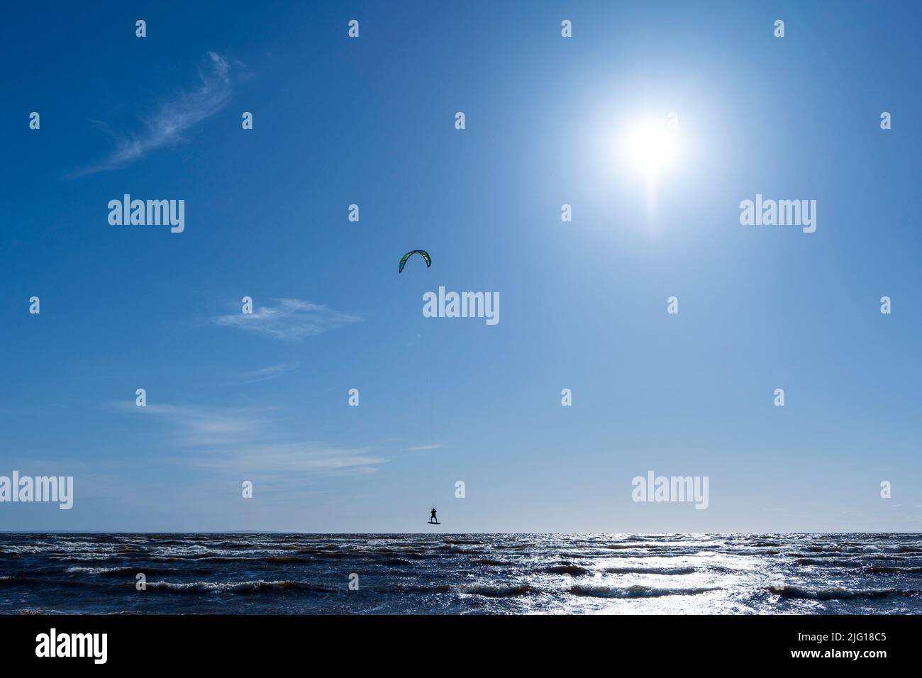 Kitesurfing at sea while performing tricks. freedom, strength, dreams. Stock Photo