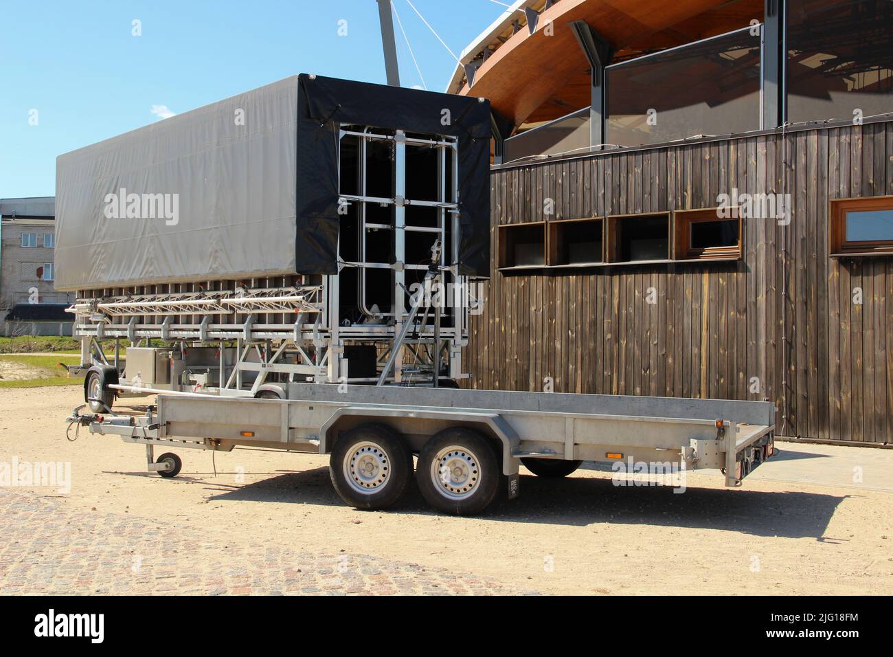 Open and roofed car trailers for commercial usage. Transportation utility for rent. Stock Photo