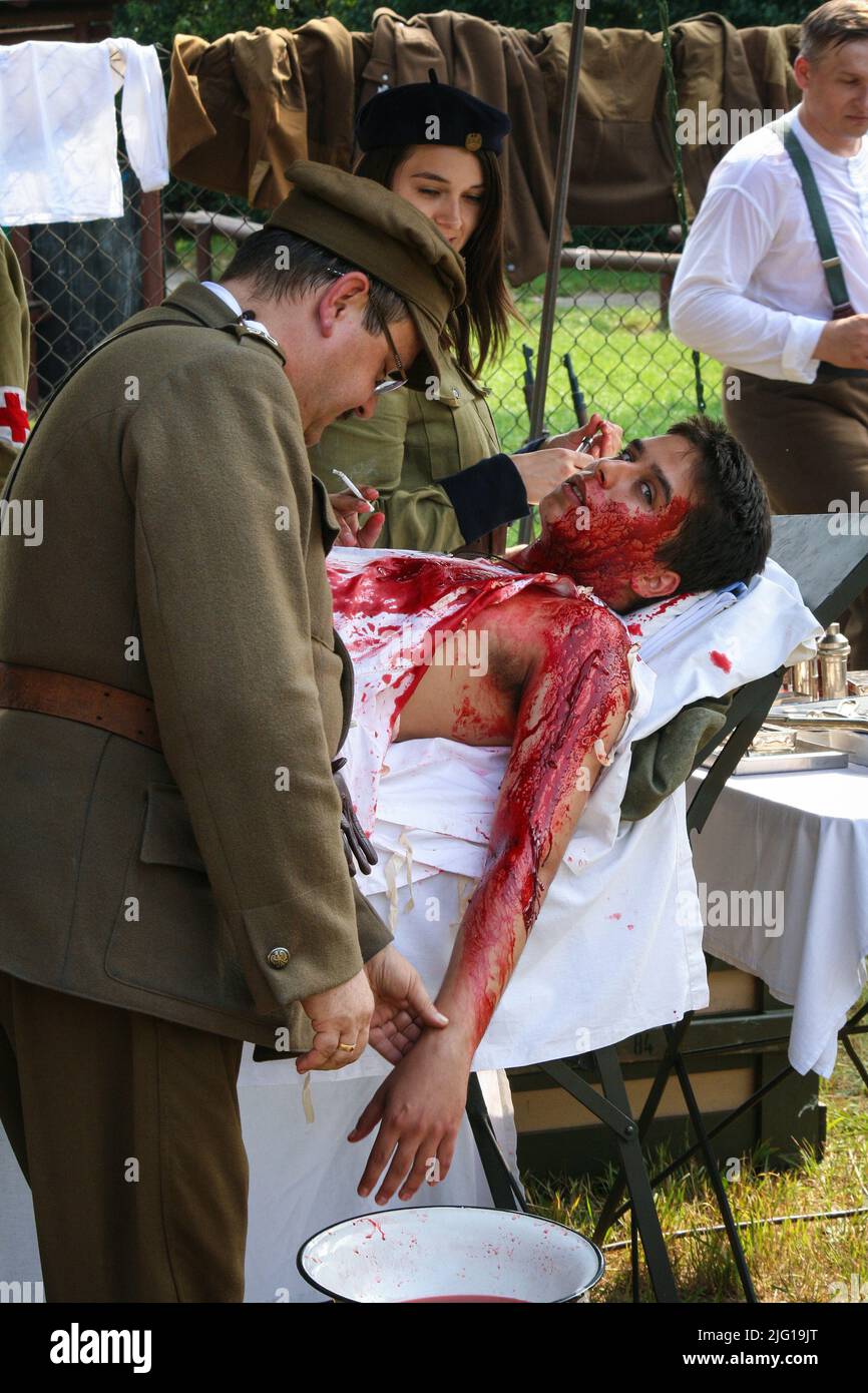 Warsaw, Poland - 15 august 2008: Dressing wound of injured soldier in staging of World War I field hospital Stock Photo