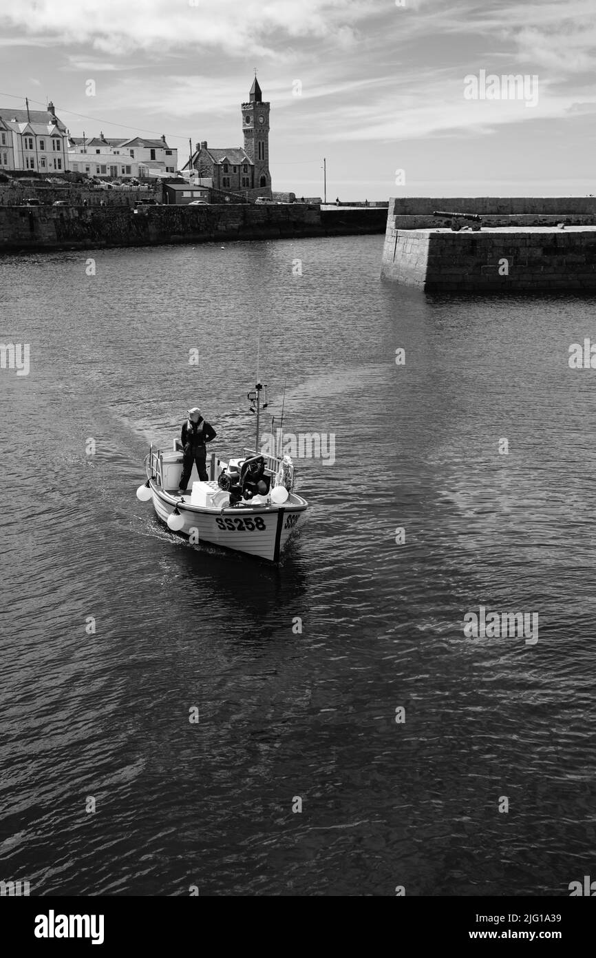 Fishing boat entering Porthleven Harbour after a morning fishing Stock ...
