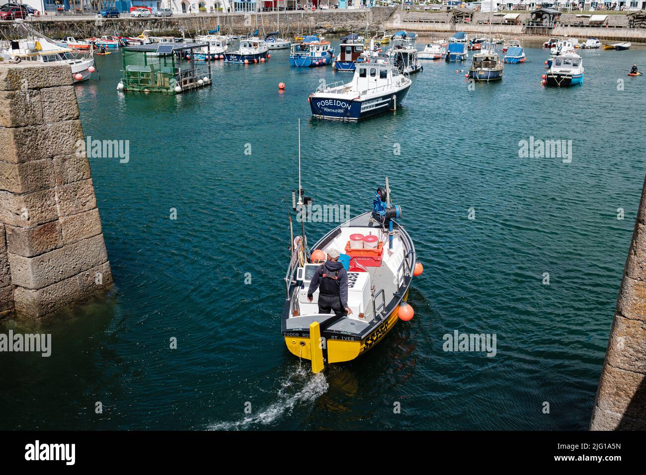 Fishing boat entering Porthleven Harbour after a morning fishing Stock ...