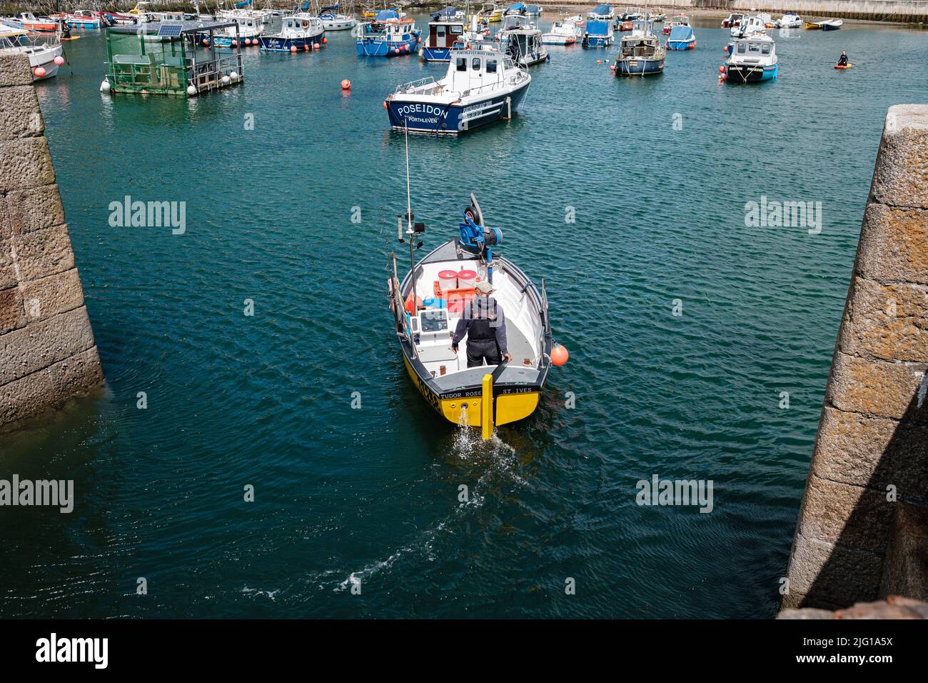 Fishing boat entering Porthleven Harbour after a morning fishing Stock ...