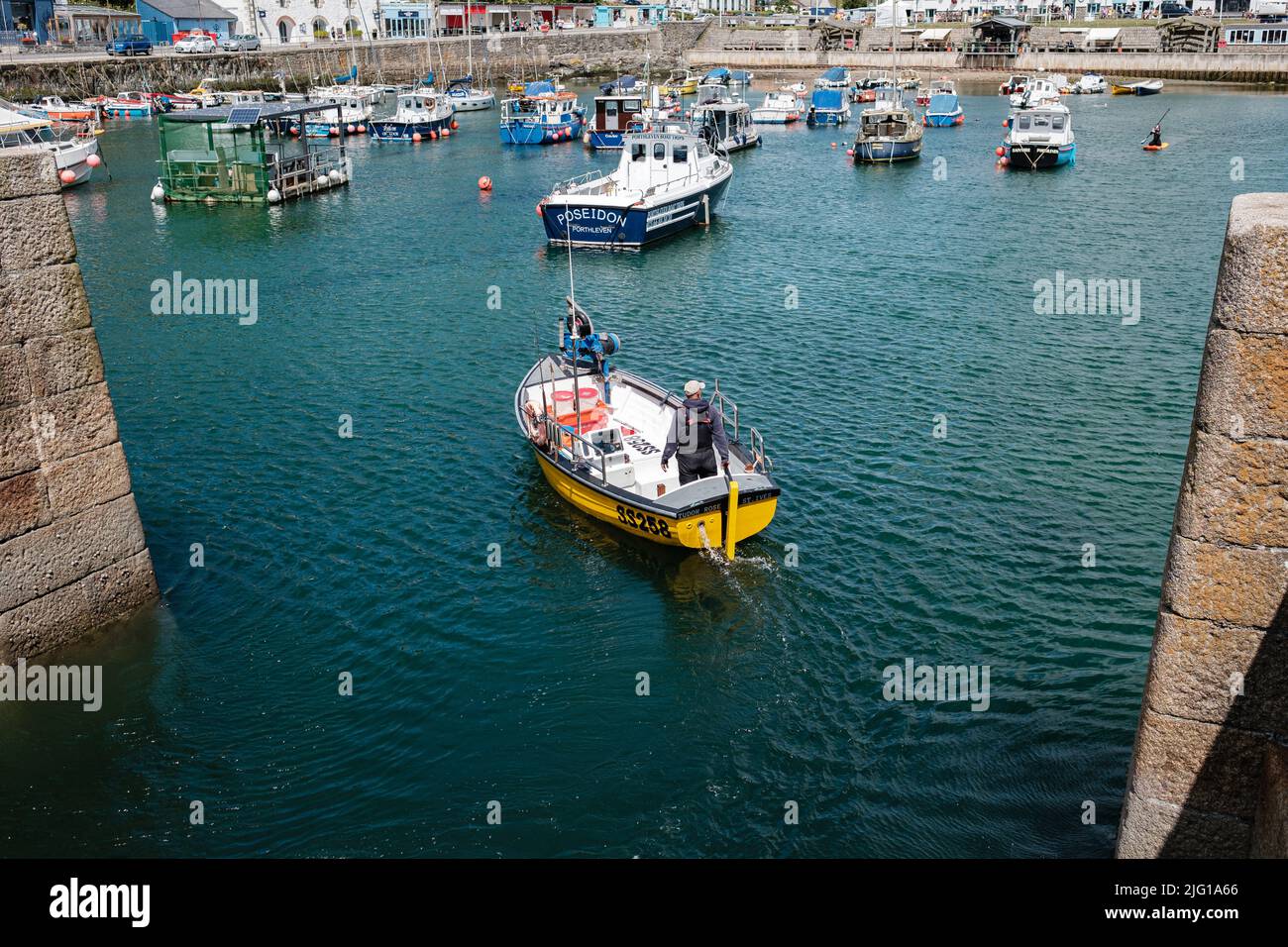 Fishing boat entering Porthleven Harbour after a morning fishing Stock ...