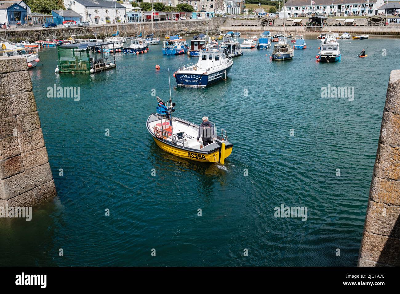 Fishing boat entering Porthleven Harbour after a morning fishing Stock