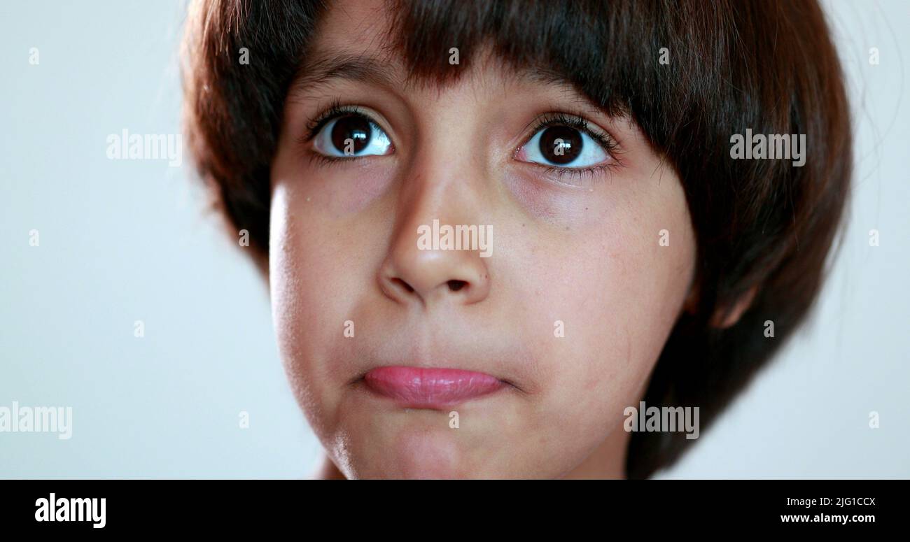 Portrait child boy thinking, close-up ethnically diverse kid looking ...