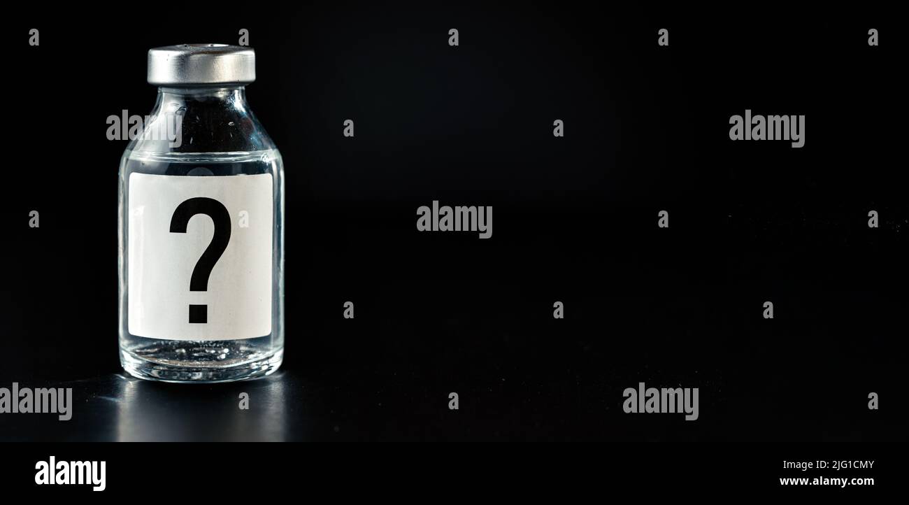 Vaccine bottle with question mark on label, black background space