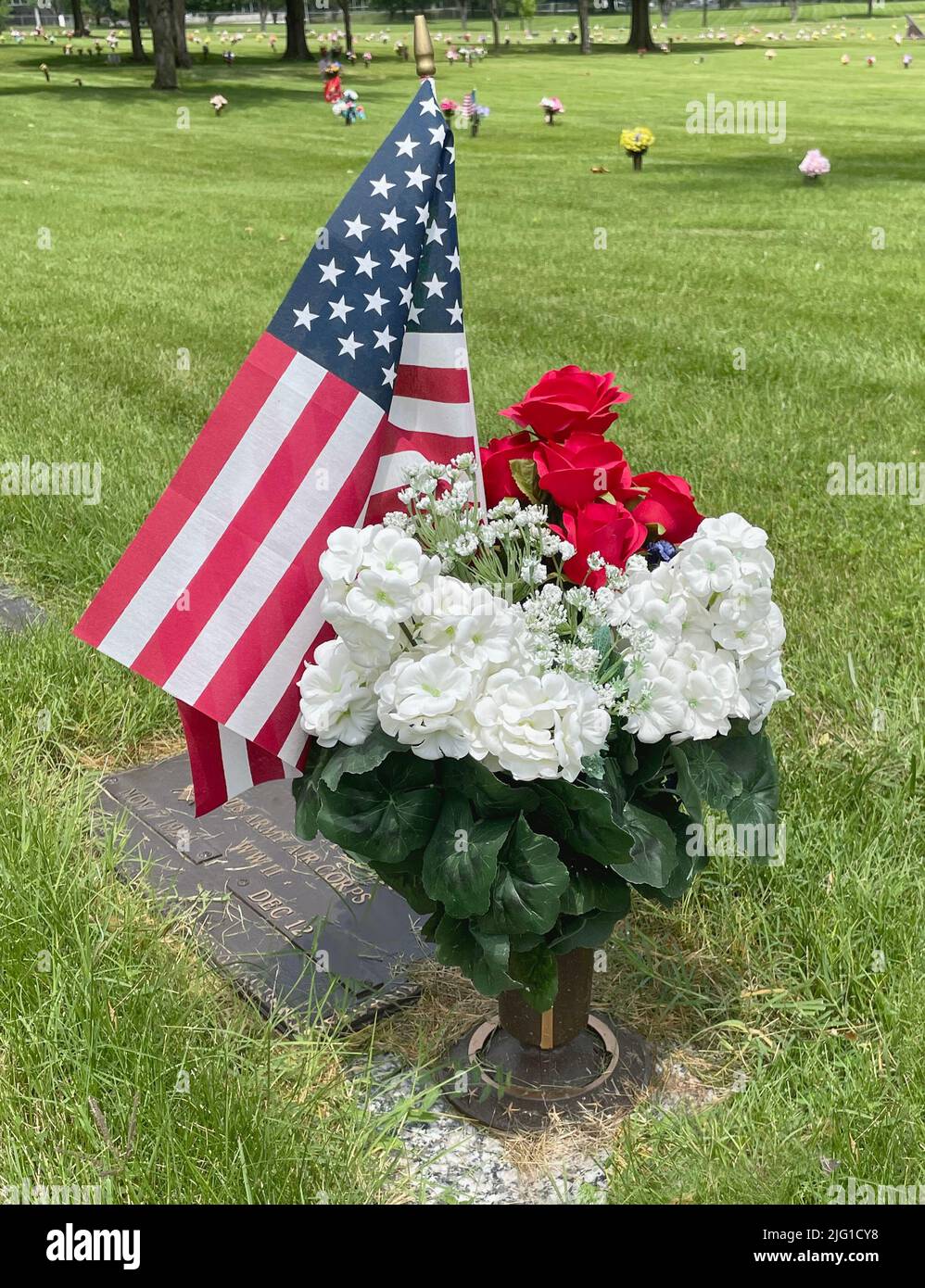 Cemetery Memorial Day flags and flowers in an urn, 2022. Stock Photo