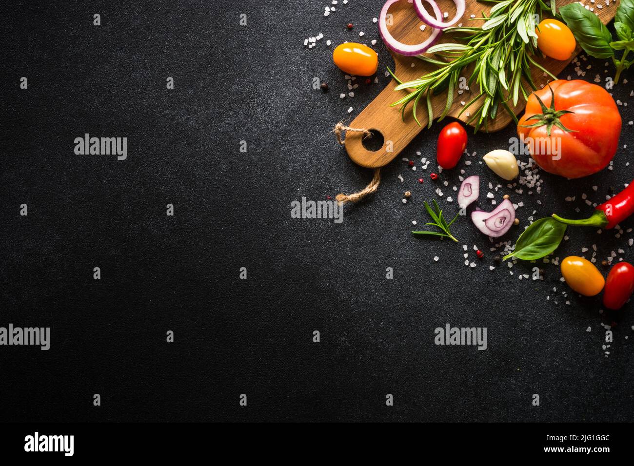 Food cooking background on black stone table Stock Photo - Alamy