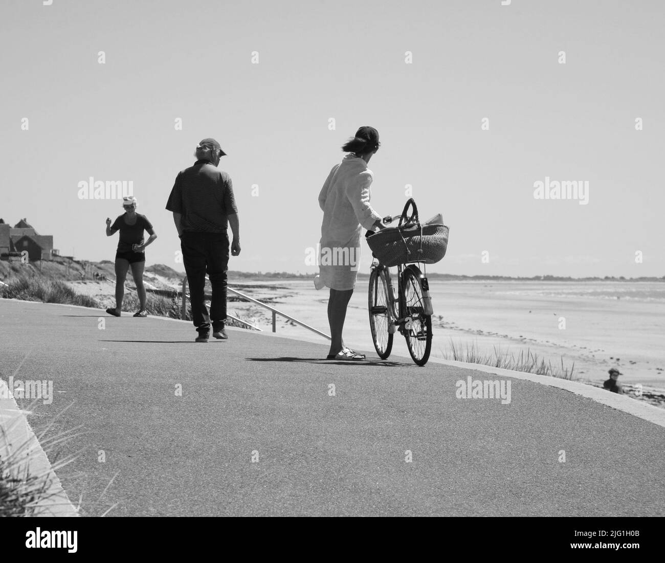 A black and white photograph of the holidaymakers on the promenade ...