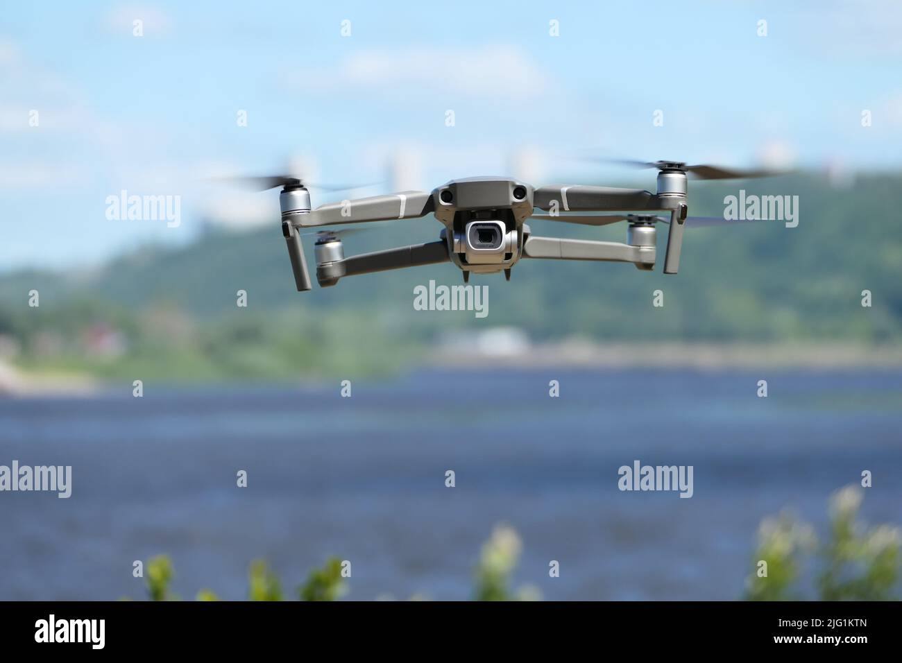 Gray quadcopter in flight. Photo-video aerial photography Stock Photo ...