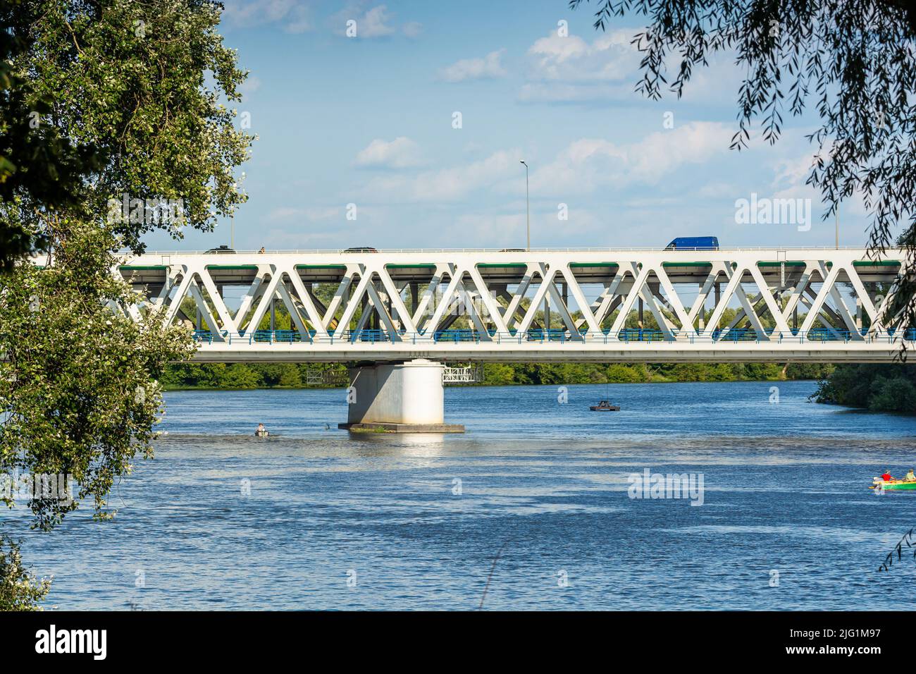 Nowy Dwor Mazowiecki, Poland - August 12, 2021. Most Pancera - Pancera Bridge over river Narew in Summer with railway for trains and road for cars Stock Photo