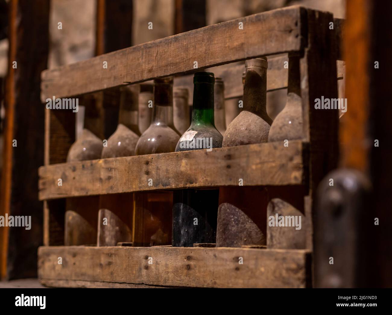 old, dusty wine bottles aging upside down in a wine cellar Stock Photo