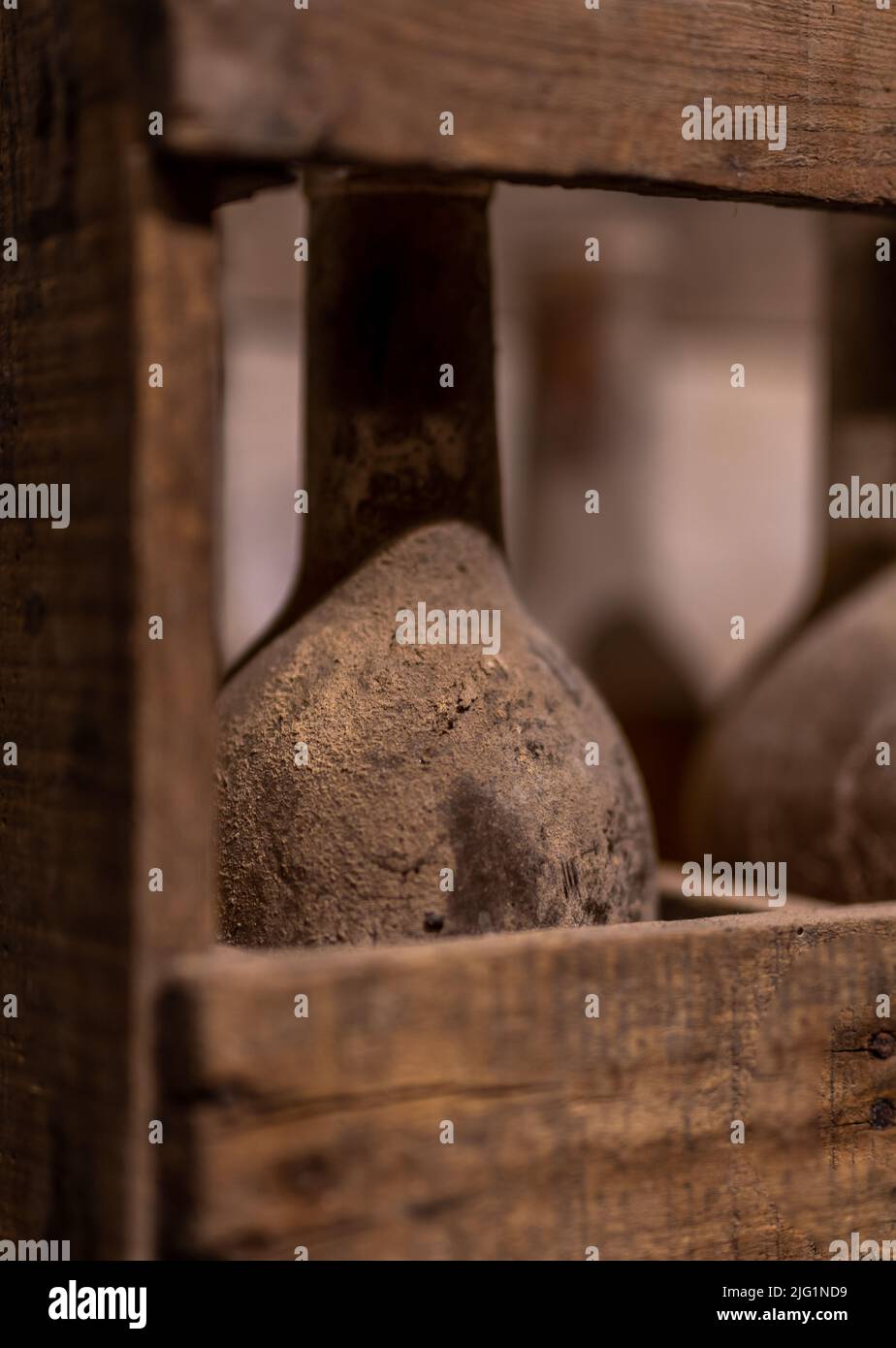 old, dusty wine bottles aging upside down in a wine cellar Stock Photo
